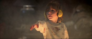 Movie still from “Face/Off” (1997), directed by John Woo – A little girl wearing ear muffs and a sweater; Medium shot, Over the shoulder angle