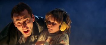 Movie still from “Face/Off” (1997), directed by John Woo – A young girl wearing ear muffs while standing next to a younger boy; Close Up shot, Low angle