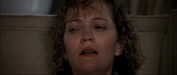 Movie still from “Face/Off” (1997), directed by John Woo – A person with a crying face; Close Up shot, Low angle