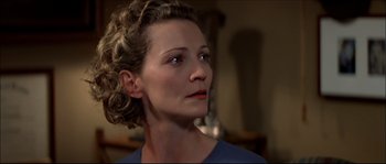 Movie still from “Face/Off” (1997), directed by John Woo – A person with curly hair; Close Up shot, Over the shoulder angle