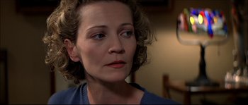 Movie still from “Face/Off” (1997), directed by John Woo – A person with curly brown hair; Close Up shot, Over the shoulder angle