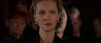 Movie still from “Face/Off” (1997), directed by John Woo – A person wearing a suit; Close Up shot, Over the shoulder angle