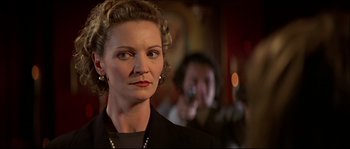 Movie still from “Face/Off” (1997), directed by John Woo – A person wearing a suit; Close Up shot, Low angle