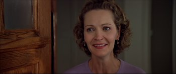 Movie still from “Face/Off” (1997), directed by John Woo – A person smiling; Close Up shot, Over the shoulder angle