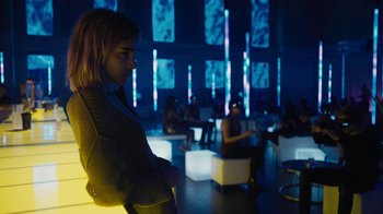 Movie still from “Fahrenheit 451” (2018), directed by Ramin Bahrani – A group of people sitting in a room with lights; Medium shot, Low angle