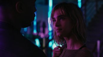 Movie still from “Fahrenheit 451” (2018), directed by Ramin Bahrani – A woman standing next to a man in a dark room; Close Up shot, Over the shoulder angle