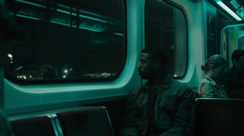 Movie still from “Fahrenheit 451” (2018), directed by Ramin Bahrani – A man sitting on a train looking out the window; Medium shot, Over the shoulder angle