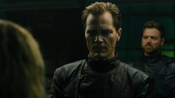 Movie still from “Fahrenheit 451” (2018), directed by Ramin Bahrani – A person wearing a leather jacket; Close Up shot, Over the shoulder angle