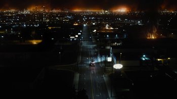 Movie still from “Fahrenheit 451” (2018), directed by Ramin Bahrani – An aerial view of a city at night with lights on; Extreme Wide shot, High angle