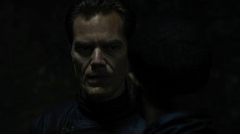 Movie still from “Fahrenheit 451” (2018), directed by Ramin Bahrani – A person wearing a black jacket; Close Up shot, Over the shoulder angle