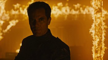 Movie still from “Fahrenheit 451” (2018), directed by Ramin Bahrani – A man in a black jacket is in a dark room; Close Up shot, Low angle