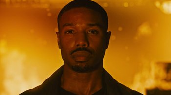 Movie still from “Fahrenheit 451” (2018), directed by Ramin Bahrani – A man's face in front of an orange background; Close Up shot, Low angle