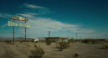 Movie still from “Fast Color” (2018), directed by Julia Hart – An empty lot with an abandoned motel and a gas station on it; Extreme Wide shot, Low angle
