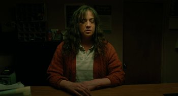 Movie still from “Fast Color” (2018), directed by Julia Hart – A woman sitting at a table with her eyes closed; Medium shot, High angle