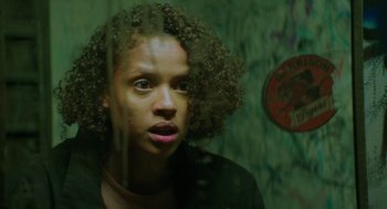 Movie still from “Fast Color” (2018), directed by Julia Hart – A woman with curly black hair looking out of a window; Close Up shot, Low angle