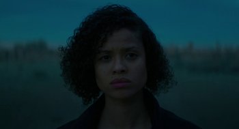 Movie still from “Fast Color” (2018), directed by Julia Hart – A young woman with curly black hair stares at the camera; Close Up shot, Low angle