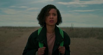 Movie still from “Fast Color” (2018), directed by Julia Hart – A woman with curly black hair wearing a black jacket; Medium shot, Low angle