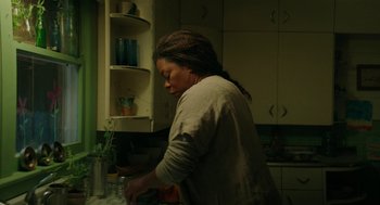 Movie still from “Fast Color” (2018), directed by Julia Hart – A woman in a kitchen preparing food on the counter; Medium shot, High angle