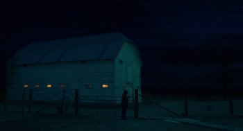 Movie still from “Fast Color” (2018), directed by Julia Hart – A person standing in front of a barn at night; Extreme Wide shot, Low angle
