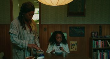 Movie still from “Fast Color” (2018), directed by Julia Hart – A woman standing at a table with a child; Medium shot, High angle