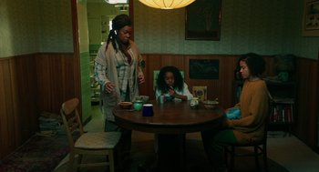 Movie still from “Fast Color” (2018), directed by Julia Hart – Three people sitting at a round table in a room; Wide shot, High angle