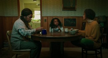 Movie still from “Fast Color” (2018), directed by Julia Hart – Three people sitting at a table with cups of coffee; Medium shot, High angle