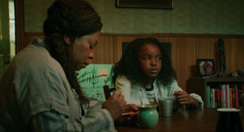Movie still from “Fast Color” (2018), directed by Julia Hart – Two people sitting at a table with a cup of coffee; Medium shot, High angle