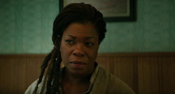 Movie still from “Fast Color” (2018), directed by Julia Hart – A person with dreadlocks looking at the camera; Close Up shot, Over the shoulder angle