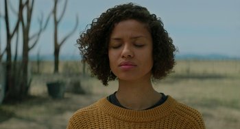 Movie still from “Fast Color” (2018), directed by Julia Hart – A woman with her eyes closed in the desert; Close Up shot, Over the shoulder angle