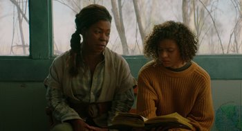 Movie still from “Fast Color” (2018), directed by Julia Hart – Two women sitting on a bench looking at a book; Medium shot, Over the shoulder angle