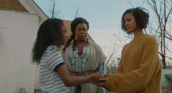 Movie still from “Fast Color” (2018), directed by Julia Hart – A group of people standing next to each other holding hands; Medium shot, Low angle