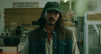 Movie still from “Fast Color” (2018), directed by Julia Hart – A man with long brown hair wearing a green hat; Medium shot, Low angle