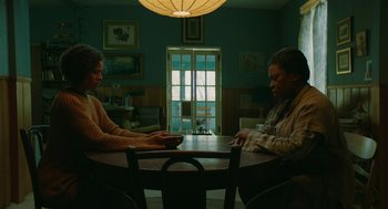 Movie still from “Fast Color” (2018), directed by Julia Hart – Two people are sitting at a table playing cards; Medium shot, Low angle