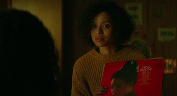 Movie still from “Fast Color” (2018), directed by Julia Hart – A woman in a sweater holding a red book; Close Up shot, Over the shoulder angle