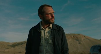 Movie still from “Fast Color” (2018), directed by Julia Hart – A man with a goatee wearing glasses and a jacket; Close Up shot, Low angle