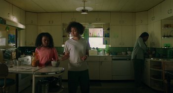 Movie still from “Fast Color” (2018), directed by Julia Hart – Two people in a kitchen with a bowl of food; Medium shot, Low angle