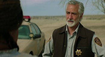 Movie still from “Fast Color” (2018), directed by Julia Hart – An older man with a sheriff's badge on his vest; Close Up shot, Over the shoulder angle