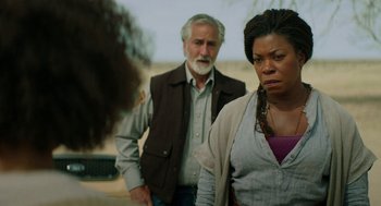 Movie still from “Fast Color” (2018), directed by Julia Hart – A man and a woman standing next to each other in front of another man; Medium shot, Over the shoulder angle