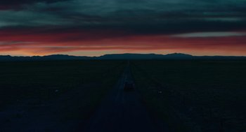 Movie still from “Fast Color” (2018), directed by Julia Hart – A car driving down a road in the middle of a field; Extreme Wide shot, Low angle
