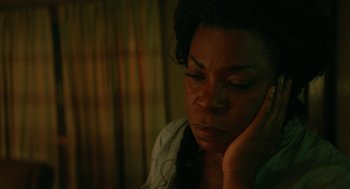 Movie still from “Fast Color” (2018), directed by Julia Hart – A person with her hand on her face; Close Up shot, High angle