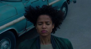 Movie still from “Fast Color” (2018), directed by Julia Hart – A woman with her eyes wide open and her head tilted to the side; Close Up shot, Low angle
