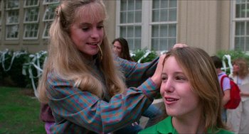 Movie still from “Fast Times at Ridgemont High” (1982), directed by Amy Heckerling – A young girl getting her hair combed by an older woman; Close Up shot, Over the shoulder angle