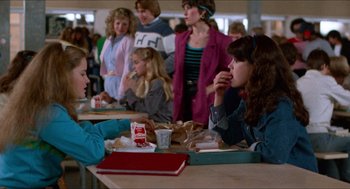 Movie still from “Fast Times at Ridgemont High” (1982), directed by Amy Heckerling – A group of people sitting at a table eating food; Medium shot, Over the shoulder angle