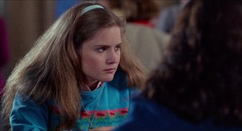 Movie still from “Fast Times at Ridgemont High” (1982), directed by Amy Heckerling – A young woman with long hair and a headband; Close Up shot, Over the shoulder angle