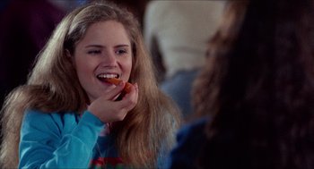 Movie still from “Fast Times at Ridgemont High” (1982), directed by Amy Heckerling – A woman eating a hot dog in front of a mirror; Close Up shot, Over the shoulder angle