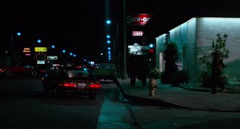 Movie still from “Fast Times at Ridgemont High” (1982), directed by Amy Heckerling – Cars parked on the side of the road at night; Extreme Wide shot, Low angle