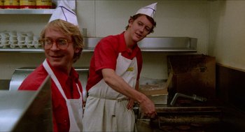 Movie still from “Fast Times at Ridgemont High” (1982), directed by Amy Heckerling – Two men wearing aprons and paper hats in a kitchen; Medium shot, Low angle