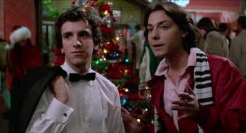 Movie still from “Fast Times at Ridgemont High” (1982), directed by Amy Heckerling – Two men standing next to each other in front of a christmas tree; Close Up shot, Low angle