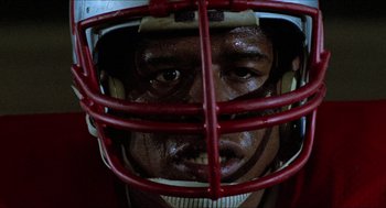 Movie still from “Fast Times at Ridgemont High” (1982), directed by Amy Heckerling – A person wearing a football helmet; Close Up shot, Low angle