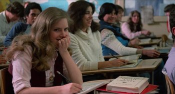 Movie still from “Fast Times at Ridgemont High” (1982), directed by Amy Heckerling – A group of women sitting at a desk in a classroom; Close Up shot, Over the shoulder angle